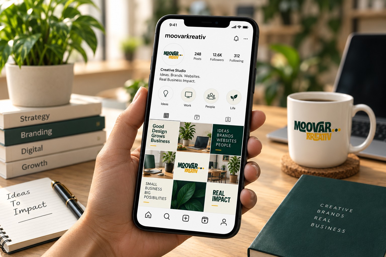 Hand holding a phone with a cream and forest-green Moovar social feed